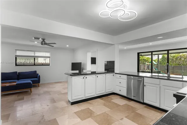 a kitchen with a sink and a stove top oven