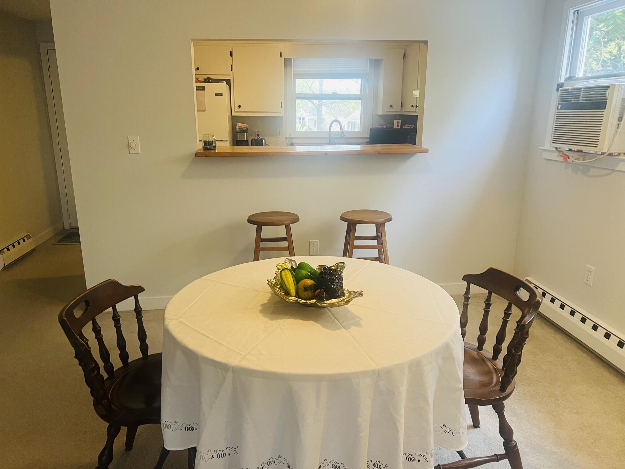 1431 Iyannough Road, Unit 1 Centerville, MA 02632 - Photo 6 of 28 a table and chairs in a kitchen