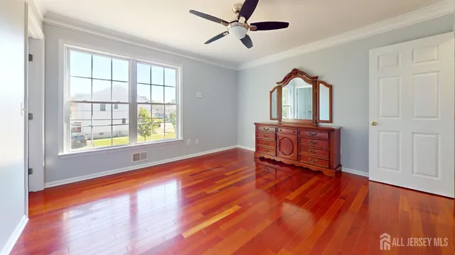 an empty room with a window and a ceiling fan