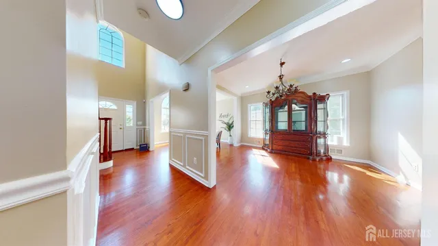 a view of an entryway with wooden floor door and a front door