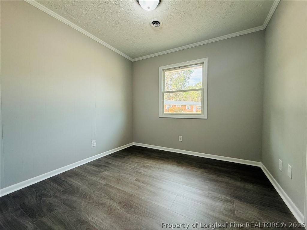 4736 Rosehill Road Fayetteville, NC 28311 - Photo 10 of 15 an empty room with wooden floor and windows