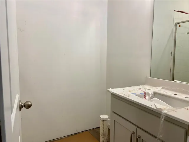 a bathroom with a sink a toilet and a mirror