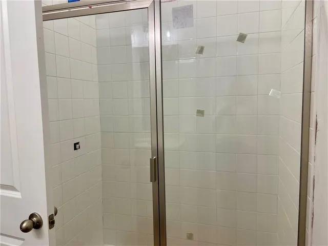 a bathroom with a glass shower door