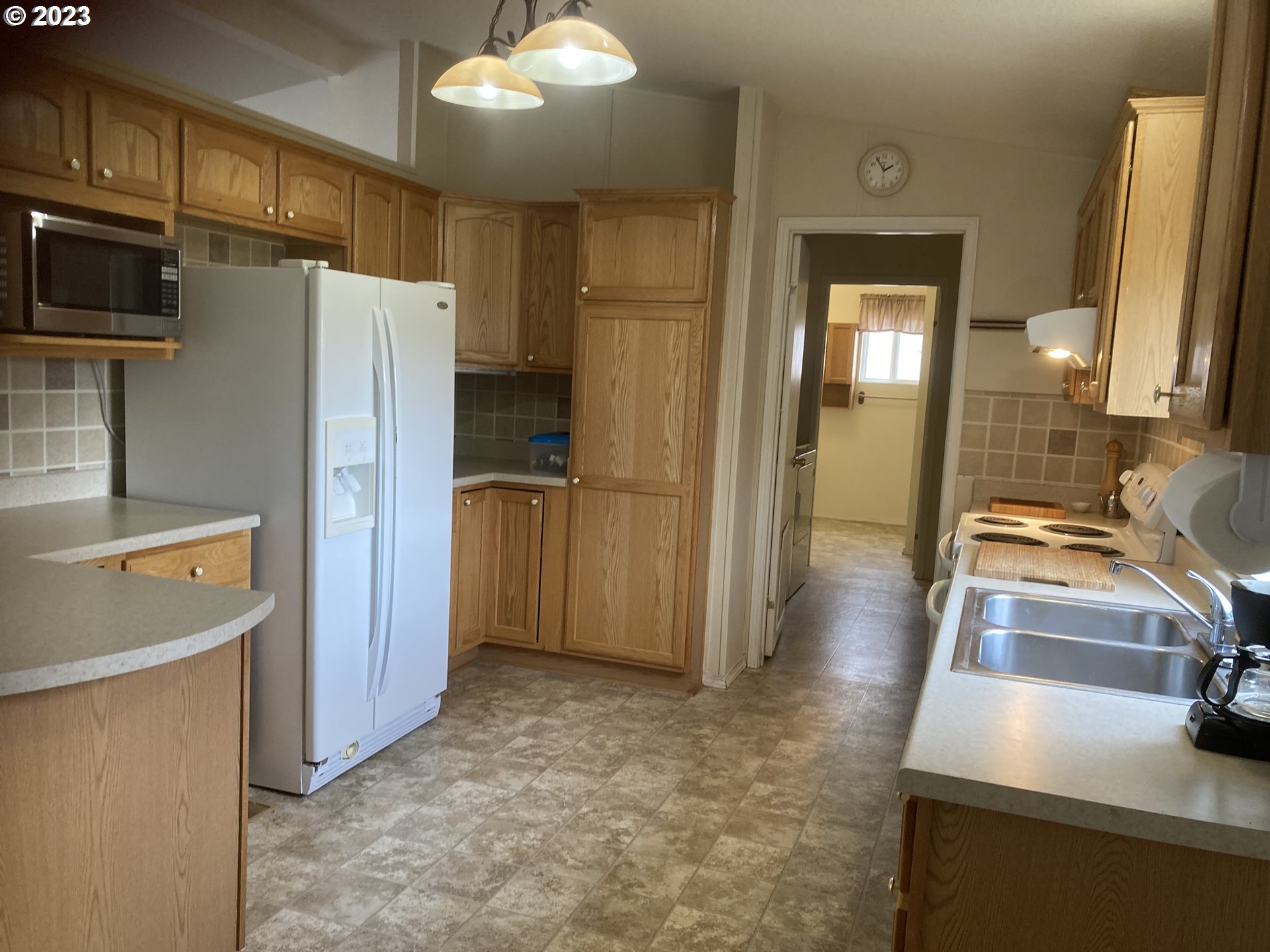 83373 Cloverdale Road Creswell, OR 97426 - Photo 8 of 28 a kitchen with refrigerator and window