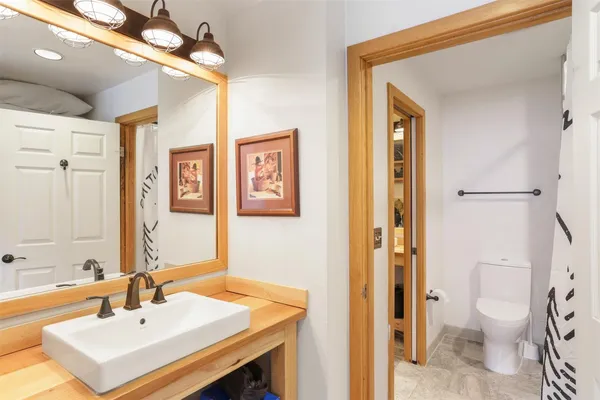a bathroom with a sink toilet and shower