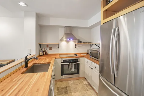 a kitchen with a sink a stove and refrigerator