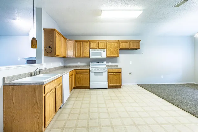 a kitchen with a stove top oven sink and cabinets