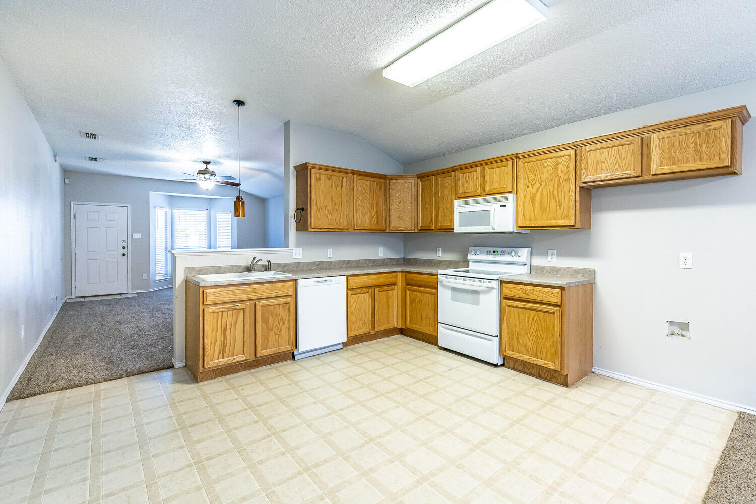 538 North Kirby Avenue Lubbock, TX 79416 - Photo 12 of 22 a kitchen with a sink cabinets and window