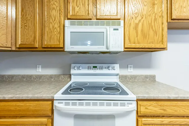 a stove top oven sitting inside of a kitchen