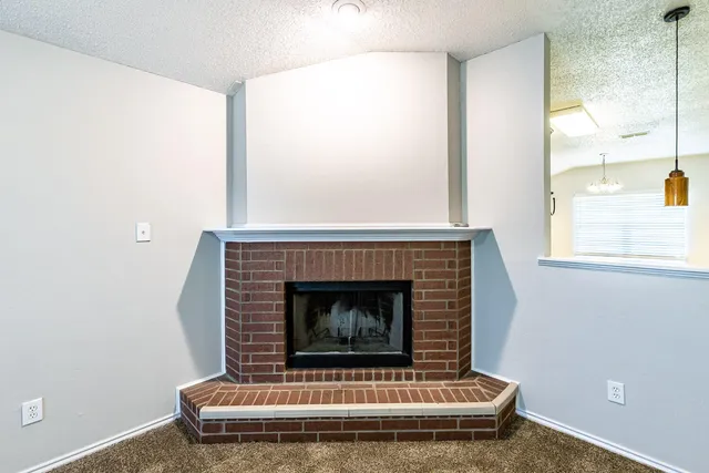 a living room with a fireplace and a window