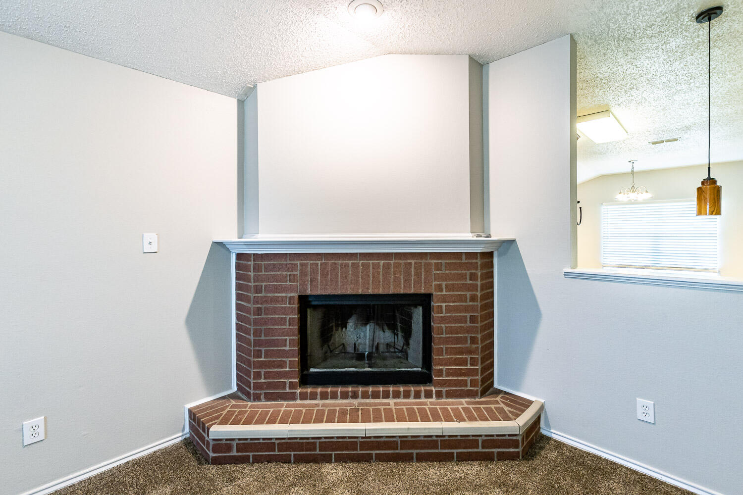 538 North Kirby Avenue Lubbock, TX 79416 - Photo 8 of 22 a living room with a fireplace and a window