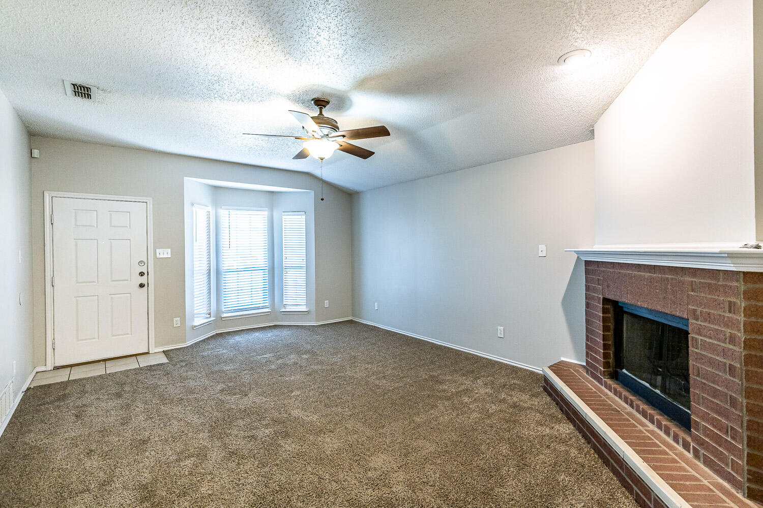 538 North Kirby Avenue Lubbock, TX 79416 - Photo 9 of 22 a view of an empty room with a fireplace
