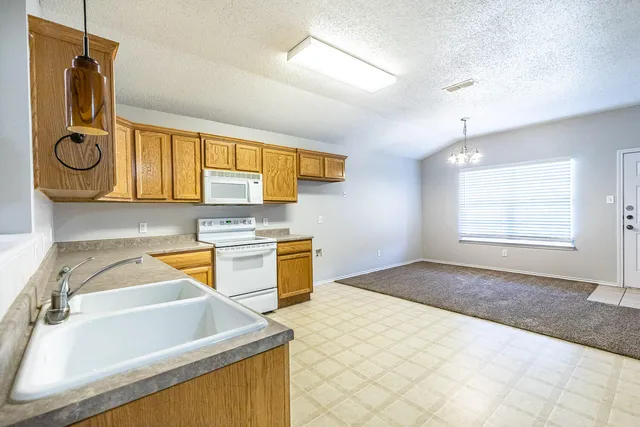 a kitchen with stainless steel appliances granite countertop a sink and cabinets