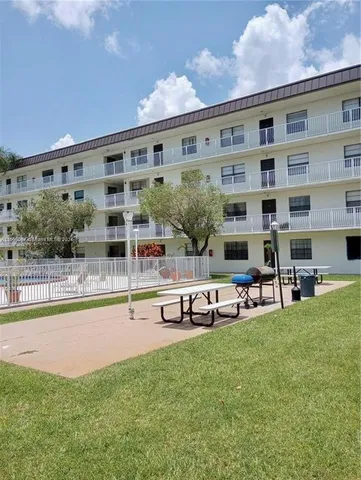 a view of a house with swimming pool and sitting area