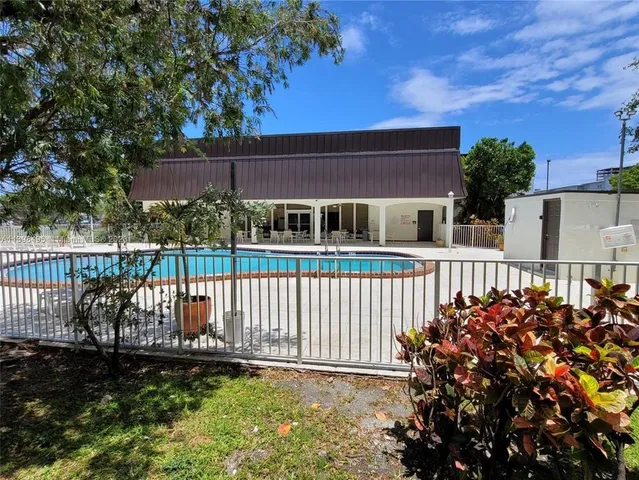 a view of a house with swimming pool and sitting area