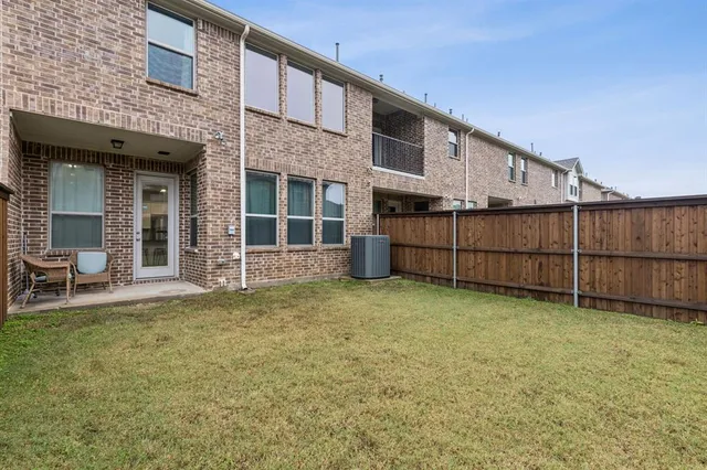 a view of a backyard with fence