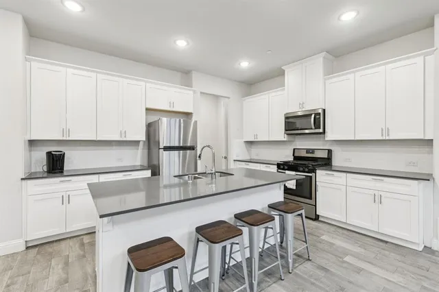 a kitchen with a sink stove and wooden cabinets