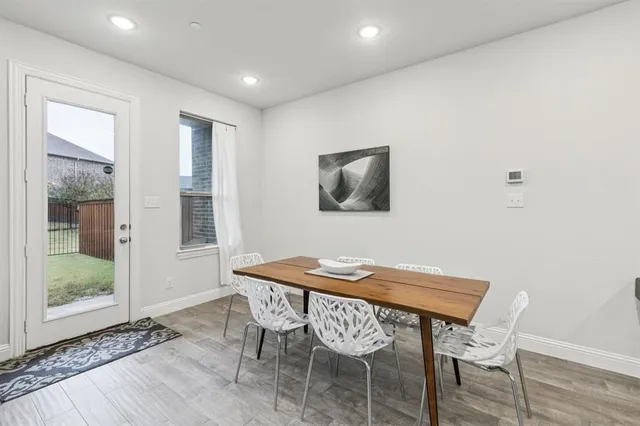 a kitchen with kitchen island granite countertop stainless steel appliances and white cabinets