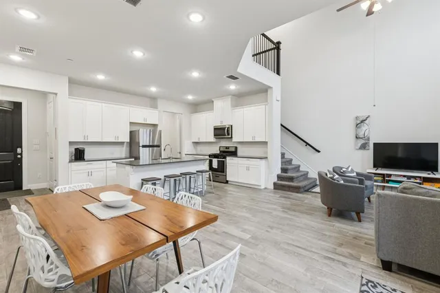 a dining room with a wooden table and chairs