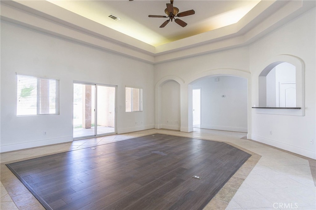 16233 Ridge View Drive Apple Valley, CA 92307 - Photo 15 of 50 a view of an empty room with wooden floor and a window