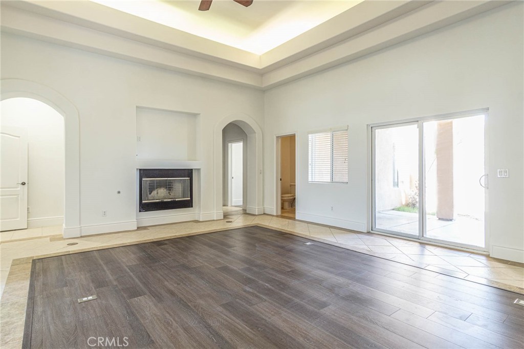 16233 Ridge View Drive Apple Valley, CA 92307 - Photo 16 of 50 an empty room with wooden floor and fireplace
