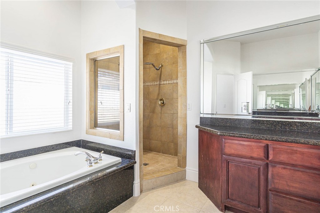16233 Ridge View Drive Apple Valley, CA 92307 - Photo 23 of 50 a bathroom with a tub a sink and a window