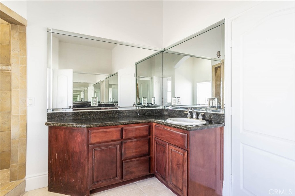 16233 Ridge View Drive Apple Valley, CA 92307 - Photo 25 of 50 a bathroom with a granite countertop sink and a mirror