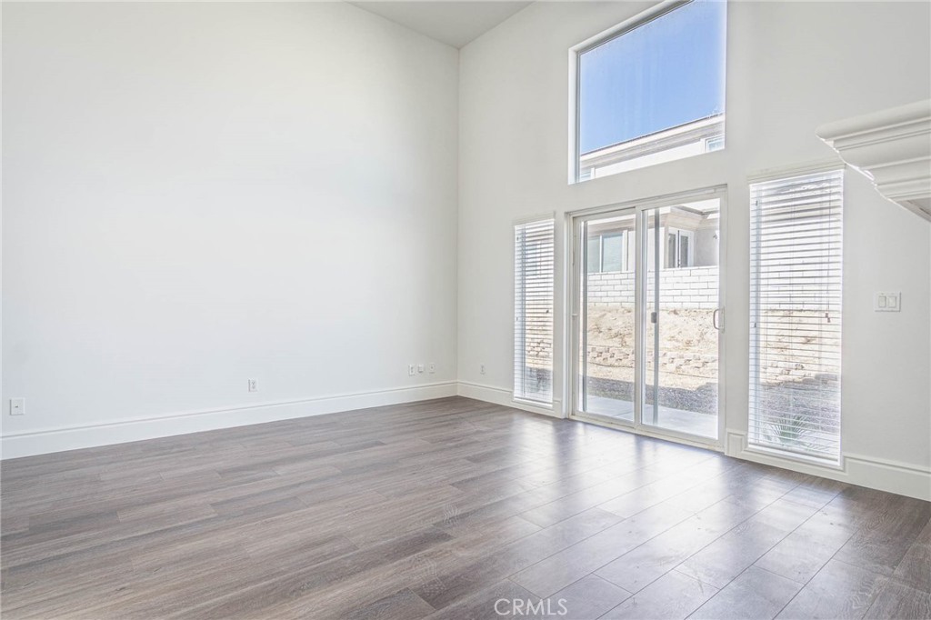 16233 Ridge View Drive Apple Valley, CA 92307 - Photo 28 of 50 a view of an empty room with wooden floor and a window