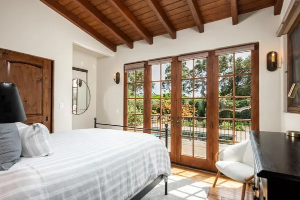 a bedroom with a large bed and a large window