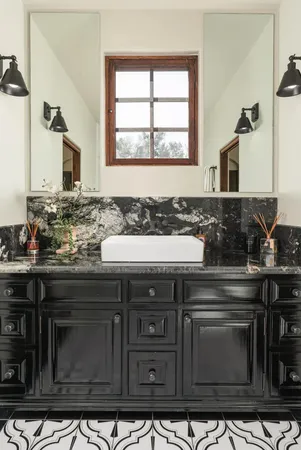 a sink with granite countertop a stove and a sink