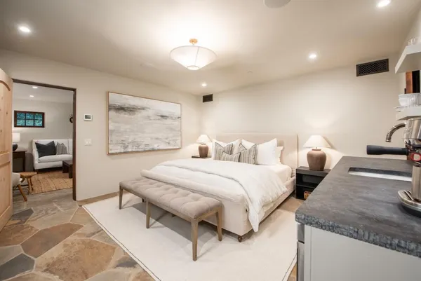 a bedroom with a bed and wooden floor