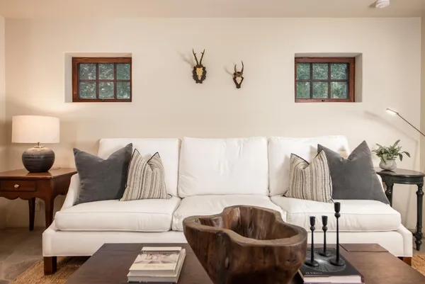 a living room with furniture and a lamp