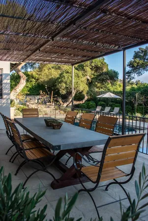 a view of a outdoor space with chairs and table in patio