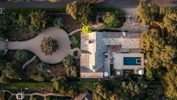 an aerial view of a house with garden space and street view