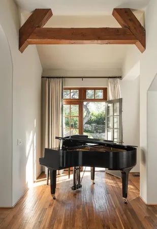 a living room with a table and a large window