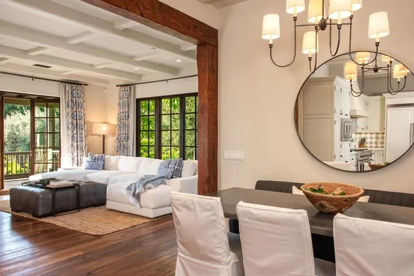 a living room with furniture a window and a chandelier