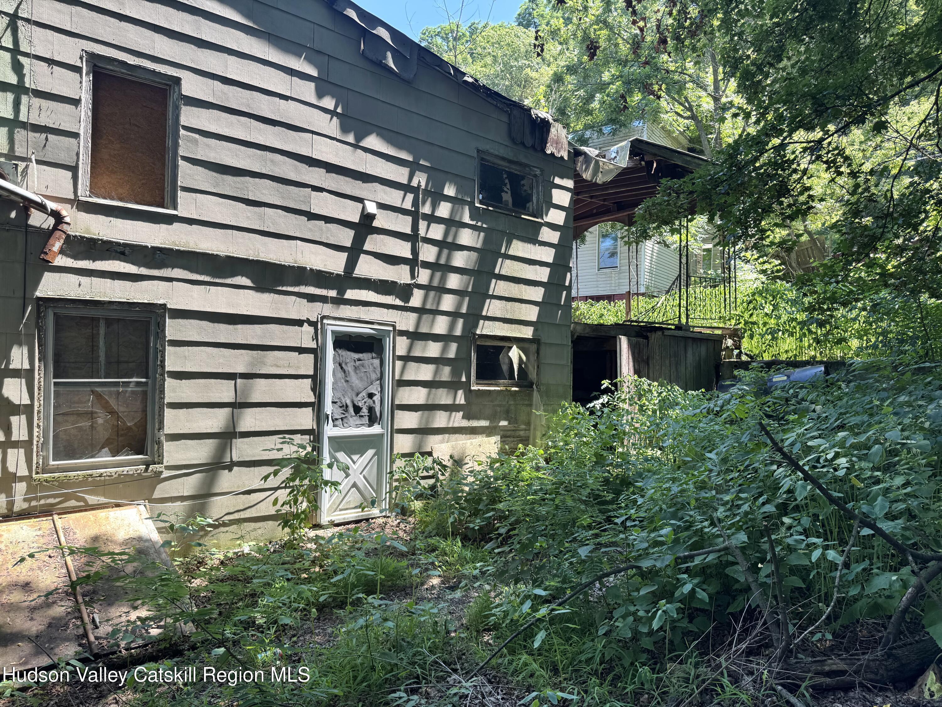 67 West Bridge Street Catskill, NY 12414 - Photo 5 of 6 a front view of a house with a garden