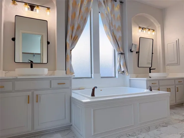 a bathroom with vanity mirror and a sink