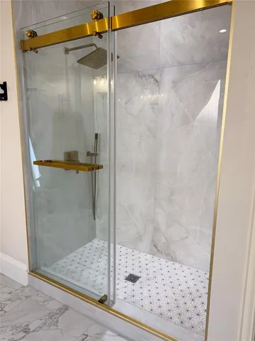 a bathroom with a glass shower door