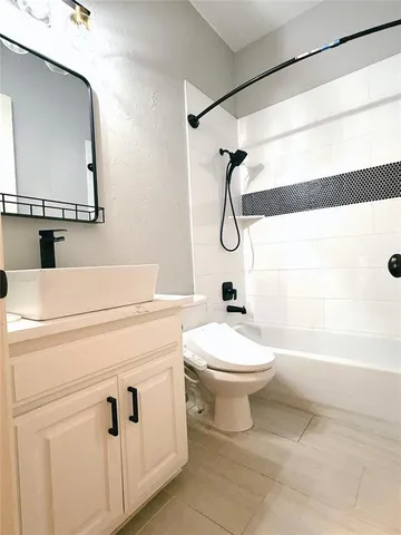 a bathroom with a toilet sink and shower