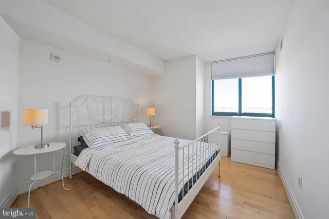 a bedroom with a bed and a lamp