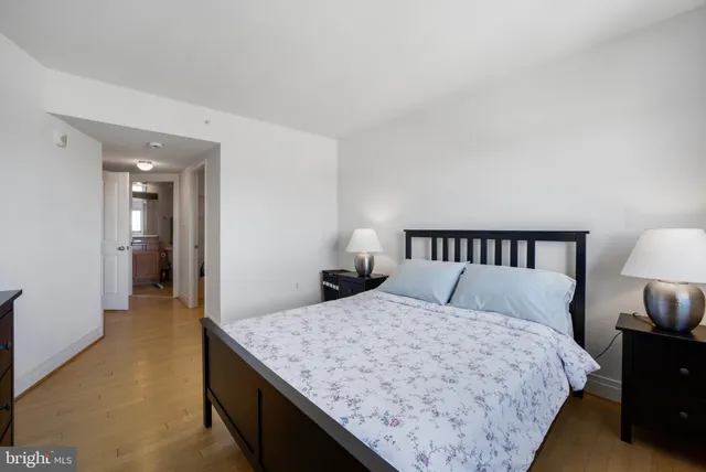 a bedroom with a large bed and a night stand