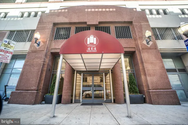 a bedroom with a bed and a chandelier fan