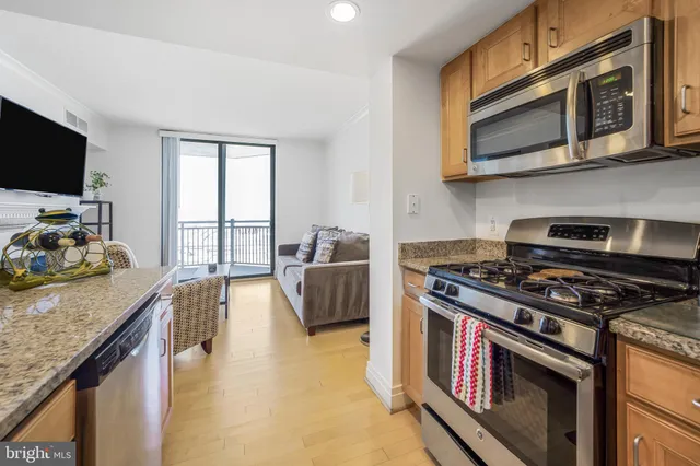 a kitchen with stainless steel appliances granite countertop a stove and a microwave