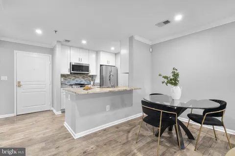 a kitchen with a table and chairs in it