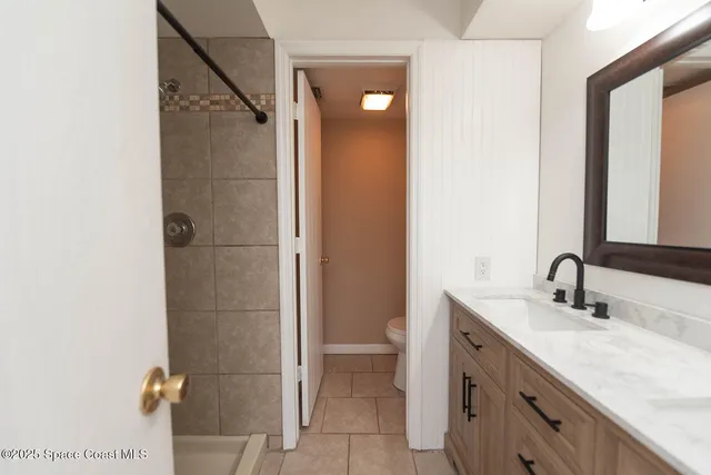 a bathroom with a shower and a sink