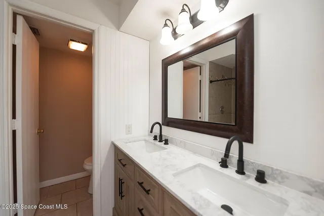 a view of a livingroom with a ceiling fan and window