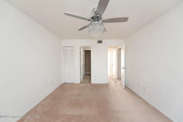 an empty room with a ceiling fan