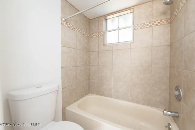 a bathroom with a toilet sink and shower