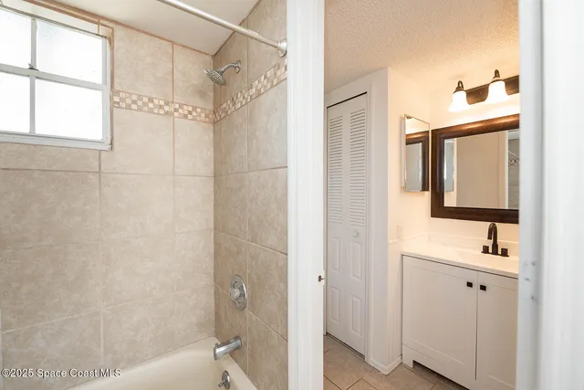 a bathroom with a sink a toilet a mirror and shower